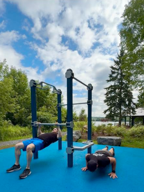 Residents using Outdoor-Fit Trail-Fit equipment for strength training at MOVE Outdoor Fitness Park