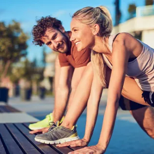 man and woman exercising outdoors