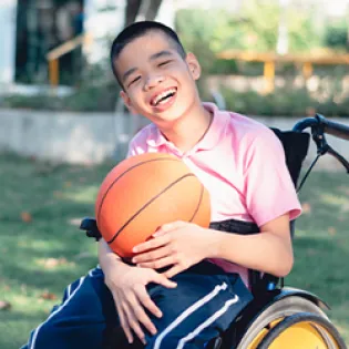 boy in wheelchair on accessible playground